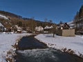 Winter landscape of small rural village Gundelfingen, Germany in Swabian Alb with GroÃÅ¸e Lauter river, snow-covered meadow.